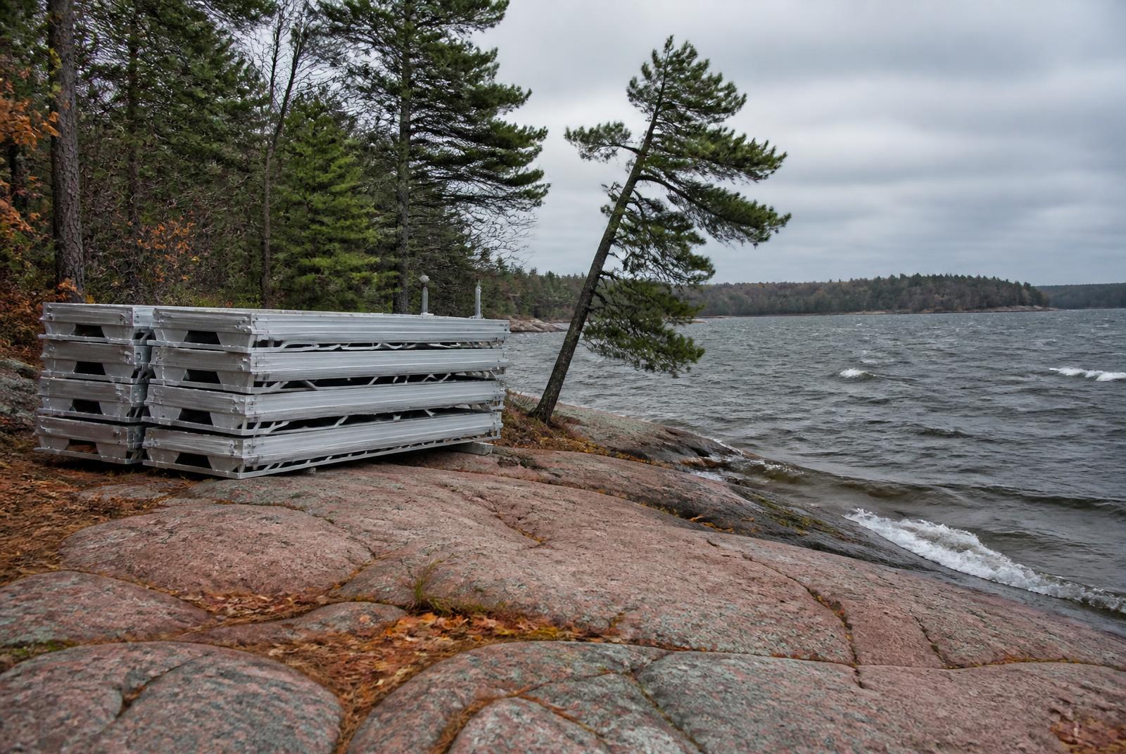 Sectional dock being moved onto a granite Georgian Bay shoreline